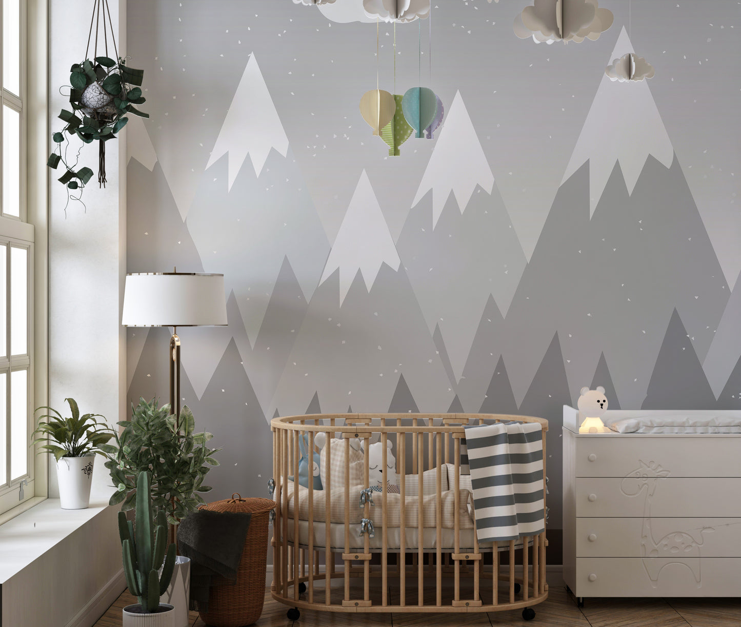 Soft grey mountain mural creating a peaceful kids' ambiance.
