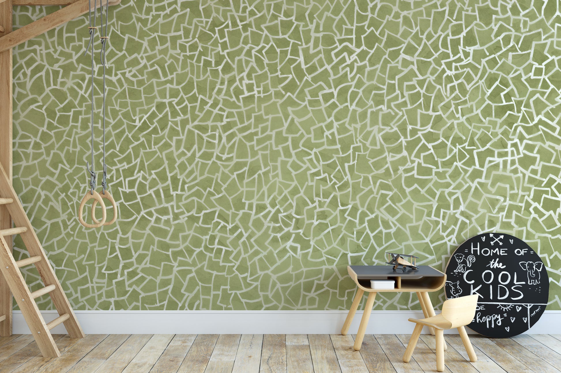 Green mosaic wall mural with abstract white geometric elements.
