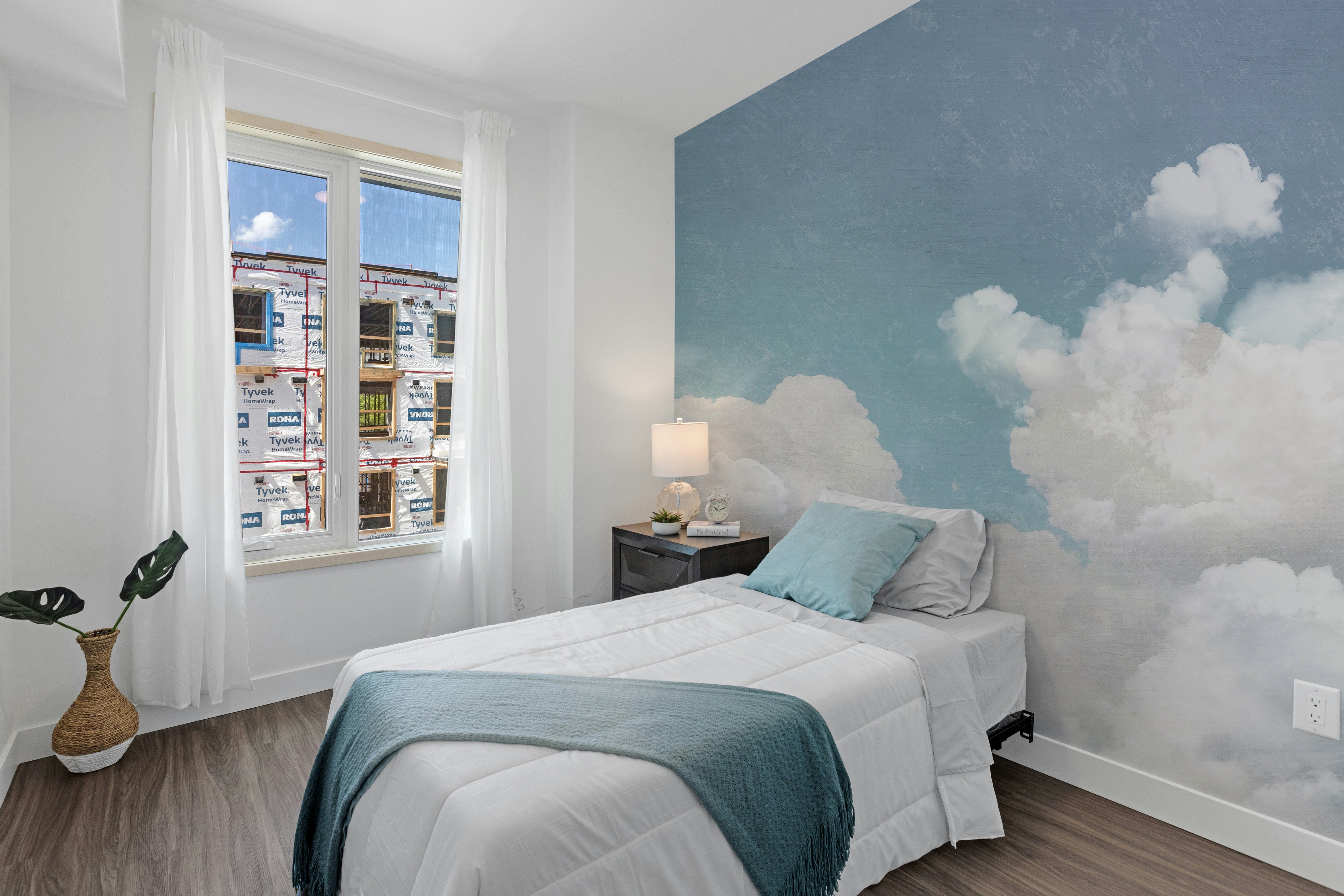 Dreamy cloudscape mural in soft tones
