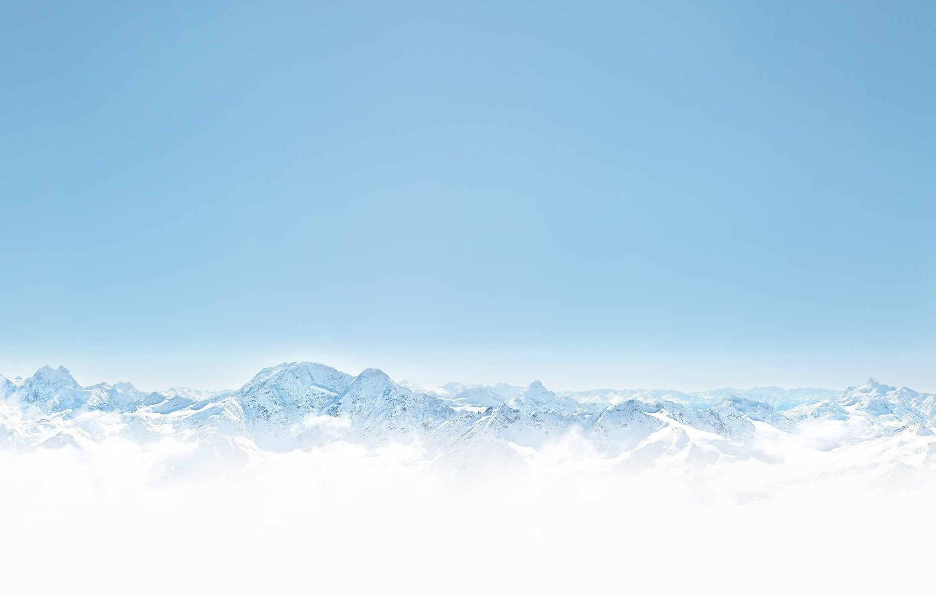 Serene winter mountain mural with snow-covered peaks and clear sky.